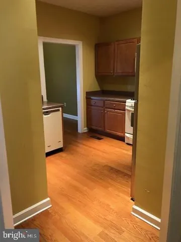 a view of kitchen with microwave and refrigerator