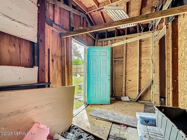 a view of a backyard with plants and a patio