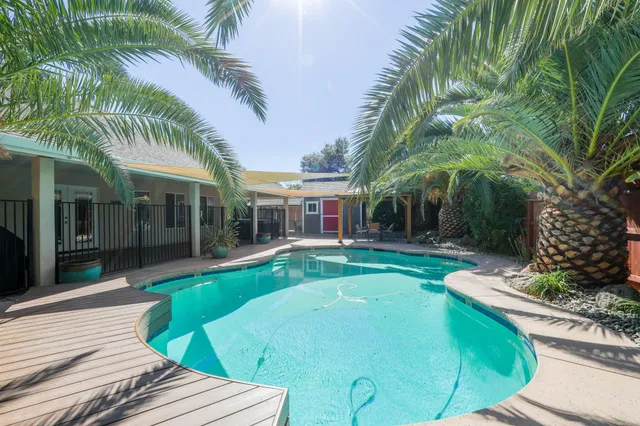 a view of a house with a yard and sitting area