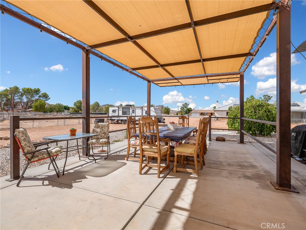 15620 Erie Road Apple Valley, CA 92307 - Photo 34 of 53 a patio with glass top table and chairs