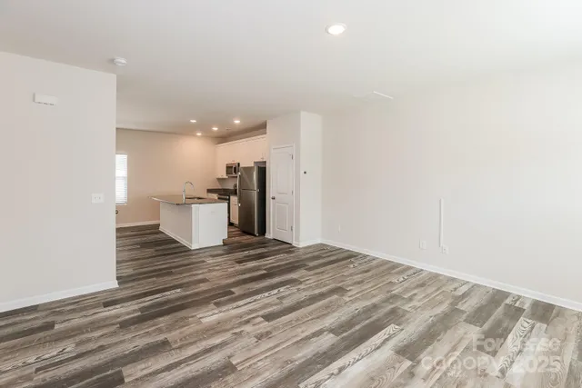 a view of a room with wooden floor