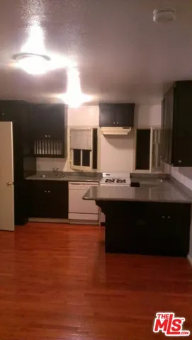 a view of kitchen with kitchen island stainless steel appliances counter space