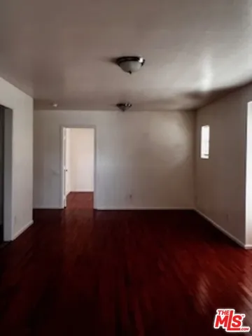 a view of an empty room and wooden floor