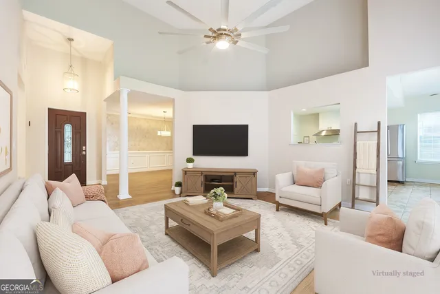 a living room with furniture and a flat screen tv
