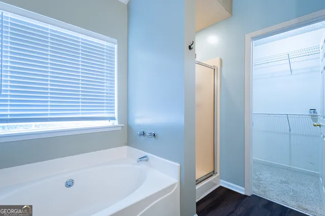 a utility room with fridge dryer and washer