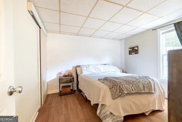 an aerial view of a house with garden space and trees all around