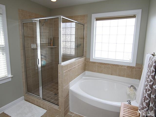 2225 Karns Place Raleigh, NC 27614 - Photo 13 of 23 Unwind in your garden tub after a hard day at work, offers separate shower, tile floor, tile shower, double vanity, and neutral paint. Master Bath/Spa