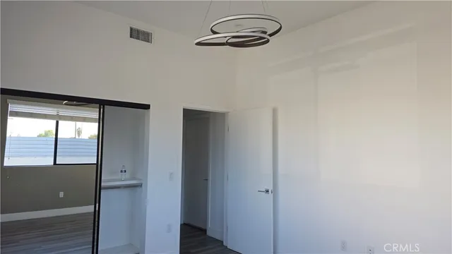 a view of a livingroom with wooden floor and window