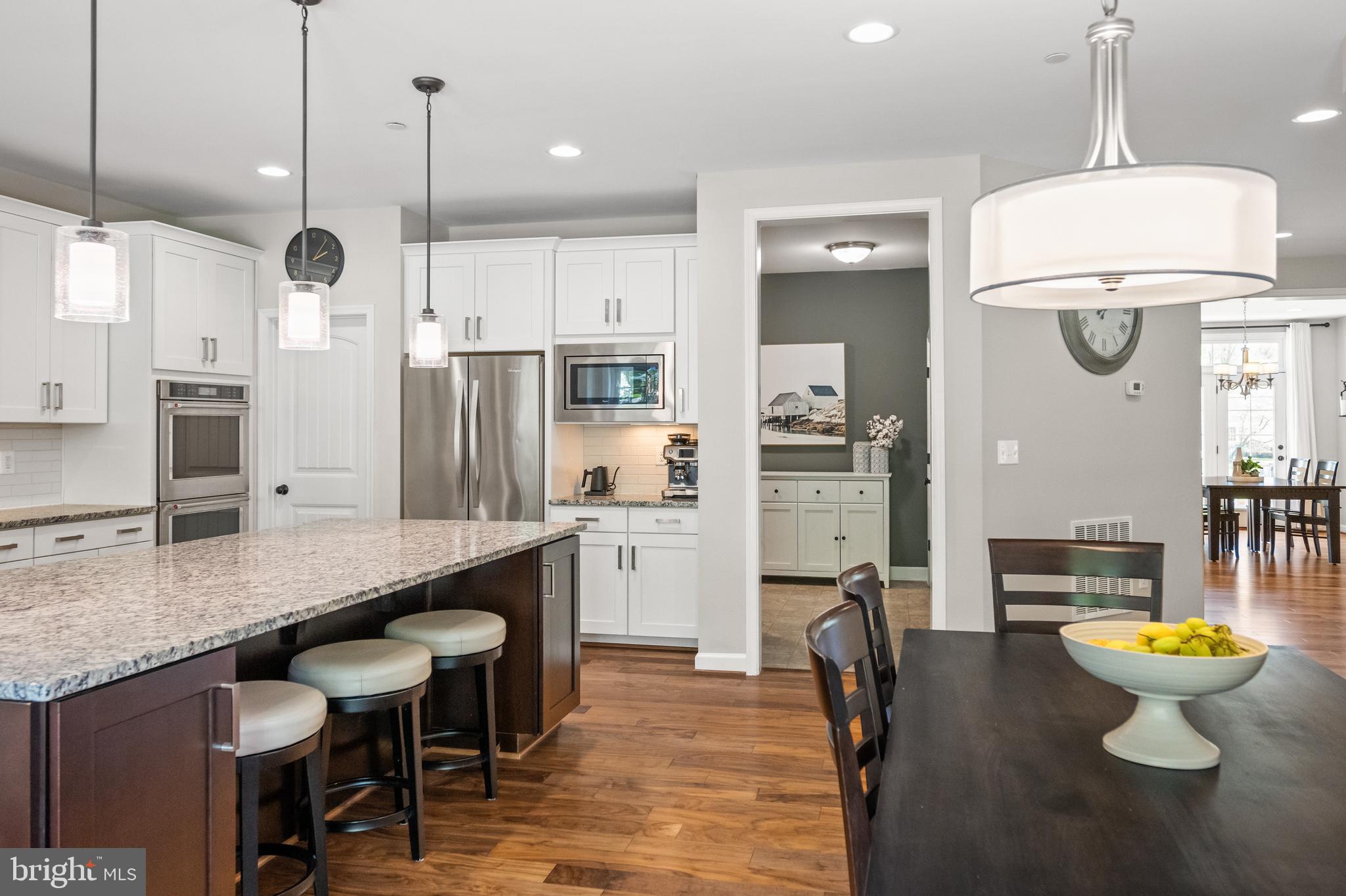 413 Vierling Drive Silver Spring, MD 20904 - Photo 22 of 82 a kitchen with a refrigerator a sink and chairs