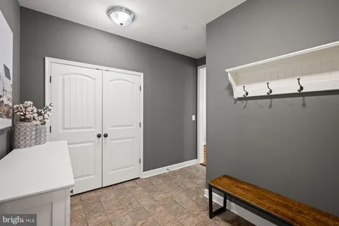 a spacious bathroom with a granite countertop sink mirror and bathtub
