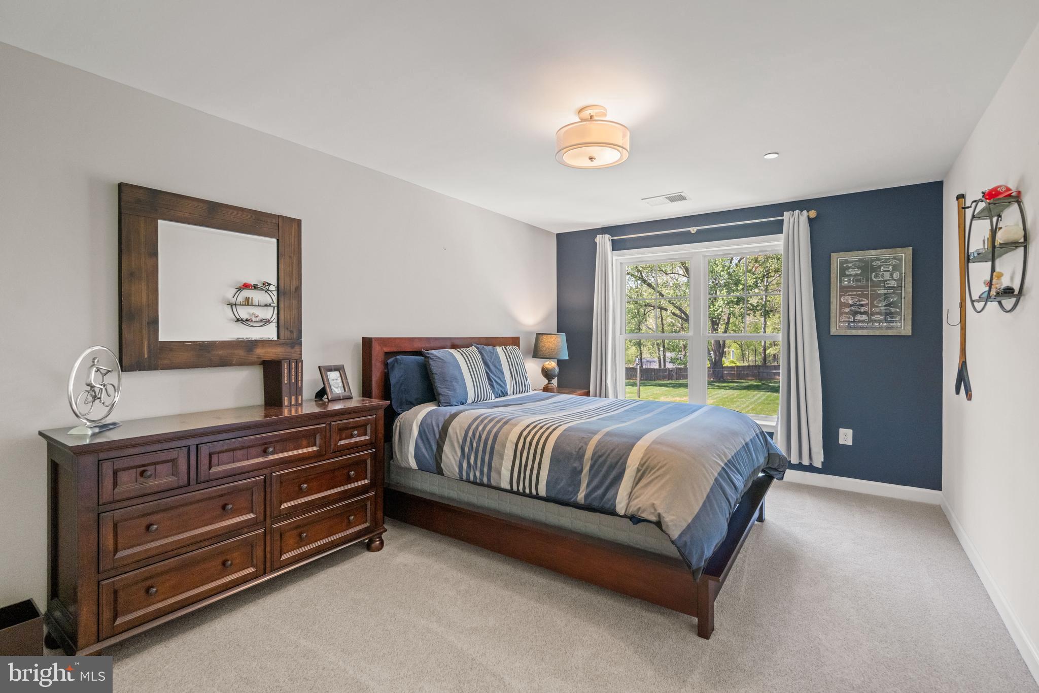 413 Vierling Drive Silver Spring, MD 20904 - Photo 48 of 82 a spacious bedroom with a bed and window