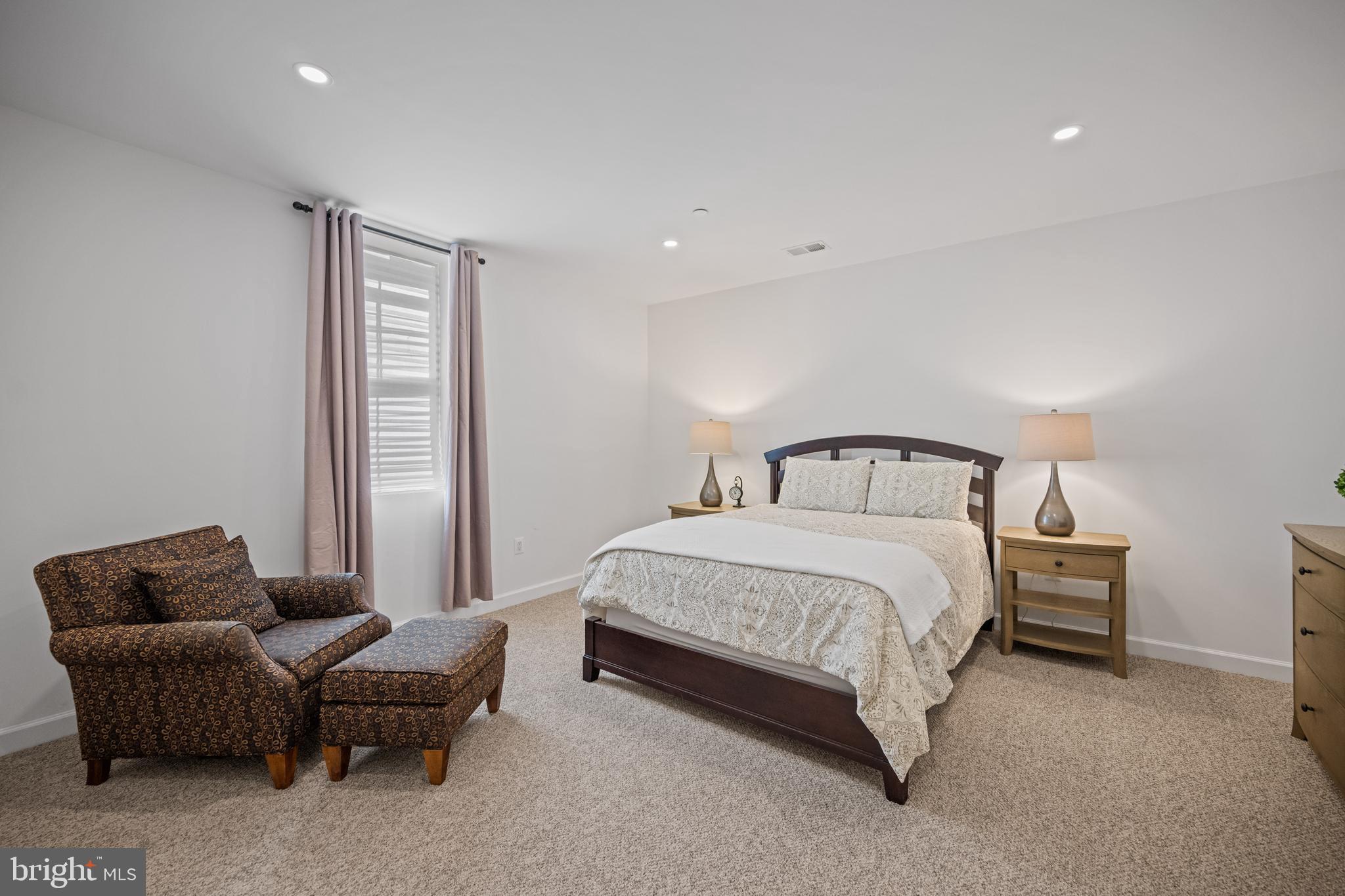 413 Vierling Drive Silver Spring, MD 20904 - Photo 67 of 82 a spacious bedroom with a bed and a couch