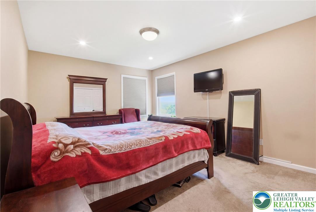 115 West Butternut Road Hellertown, PA 18055 - Photo 46 of 97 Recessed lighting and ample windows illuminate this comfortable bedroom space.