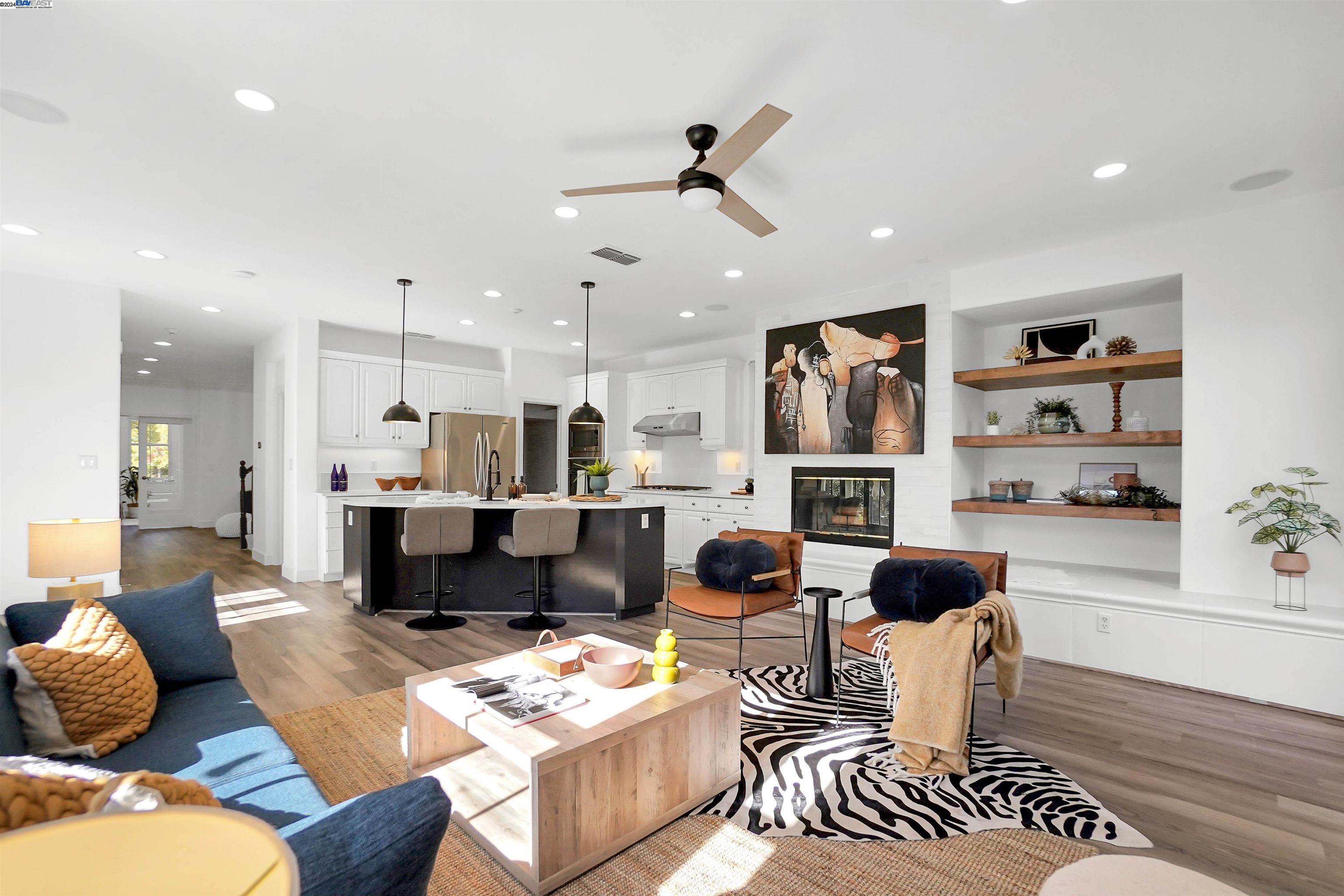 a living room with furniture and kitchen view