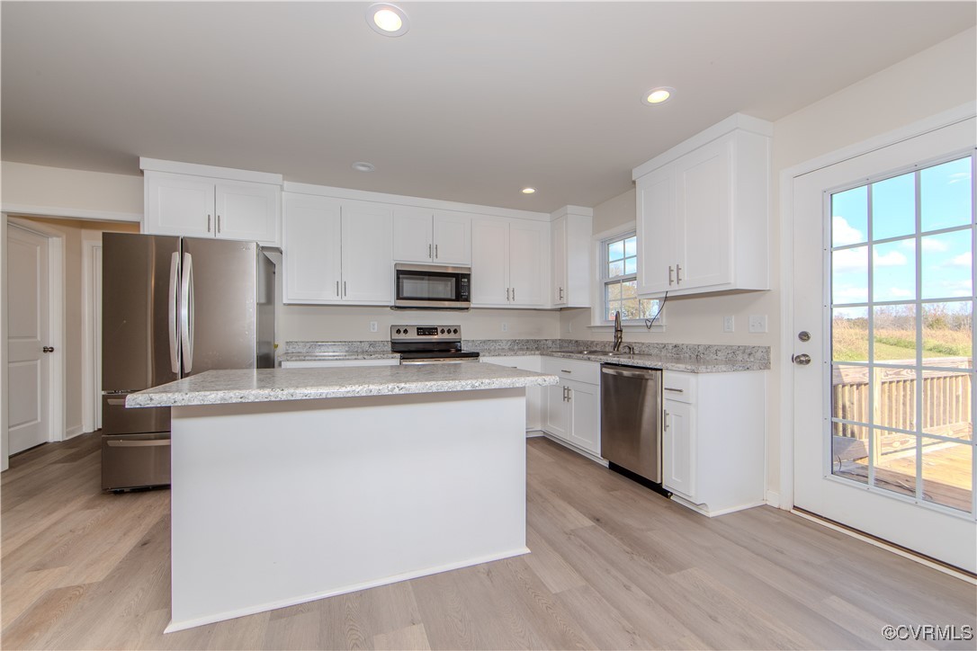14671 Baltimore Road Dewitt, VA 23840 - Photo 3 of 27 a kitchen with kitchen island a white cabinets and refrigerator
