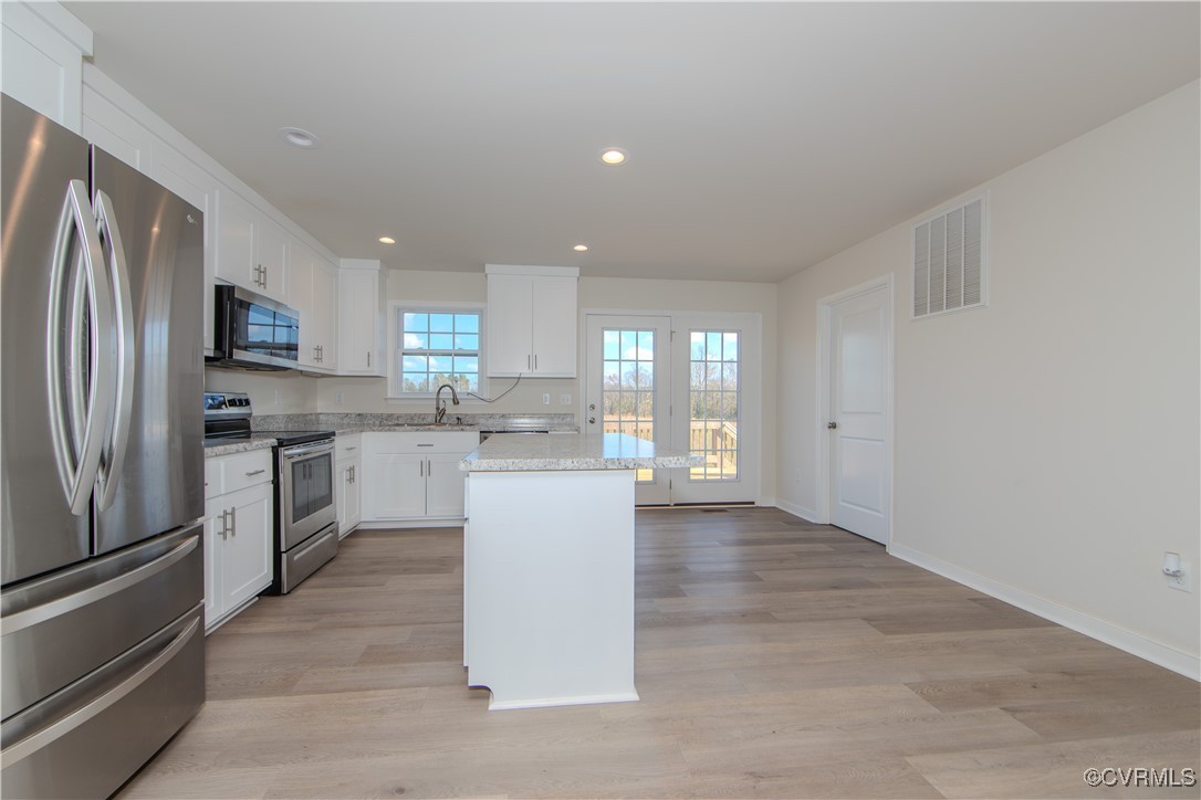14671 Baltimore Road Dewitt, VA 23840 - Photo 5 of 27 a kitchen with a refrigerator and a sink