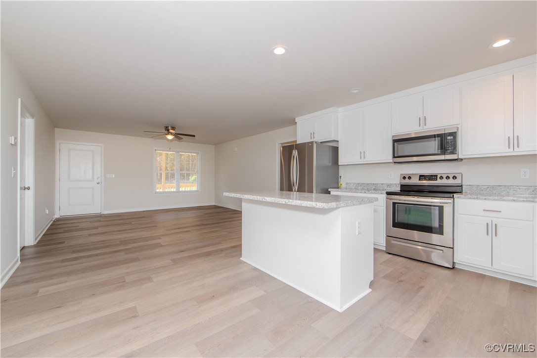 14671 Baltimore Road Dewitt, VA 23840 - Photo 6 of 27 a kitchen with granite countertop white cabinets and white appliances
