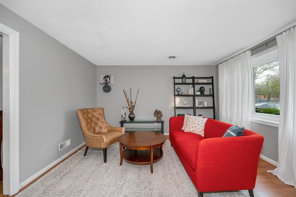 43 Constitution Way, Unit 43 Methuen, MA 01844 - Photo 5 of 25 a living room with furniture and a large window