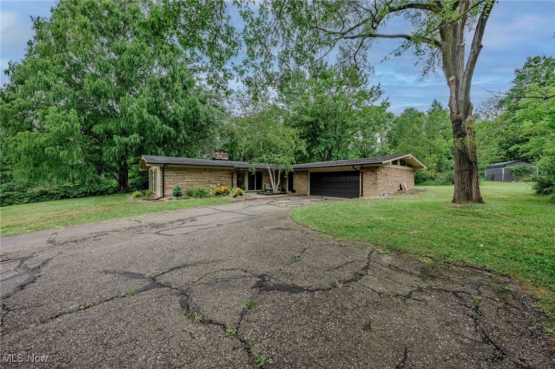 3381 Barrett Road Akron, OH 44333 - Photo 41 of 50 Mid-century home featuring a garage, a front lawn, driveway, and a chimney