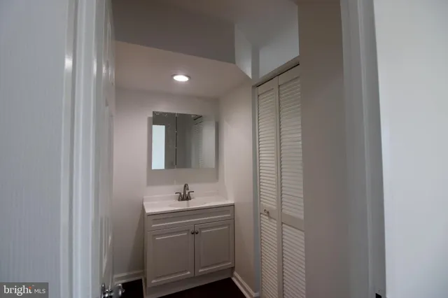 a bathroom with a shower sink and mirror