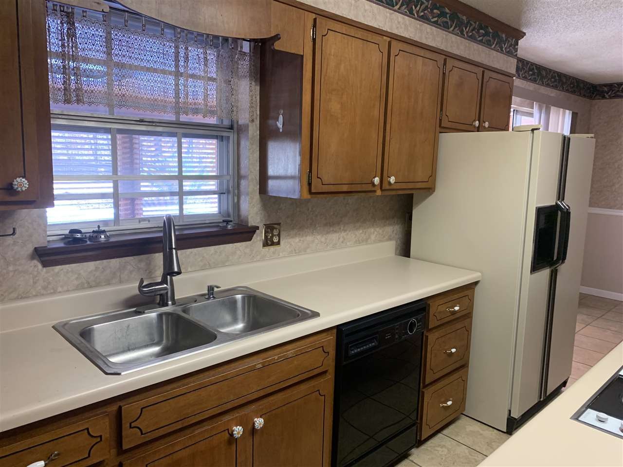 483 Kinser Road Cleveland, TN 37323 - Photo 10 of 40 a kitchen with a sink a refrigerator and cabinets