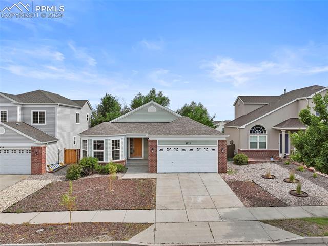 6725 Akron Road Colorado Springs, CO 80923 - Photo 2 of 50 View of front property featuring a garage