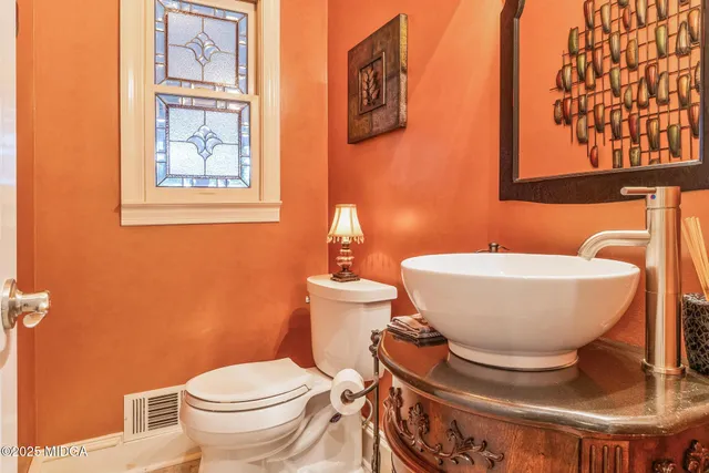 a bathroom with a sink a toilet and mirror