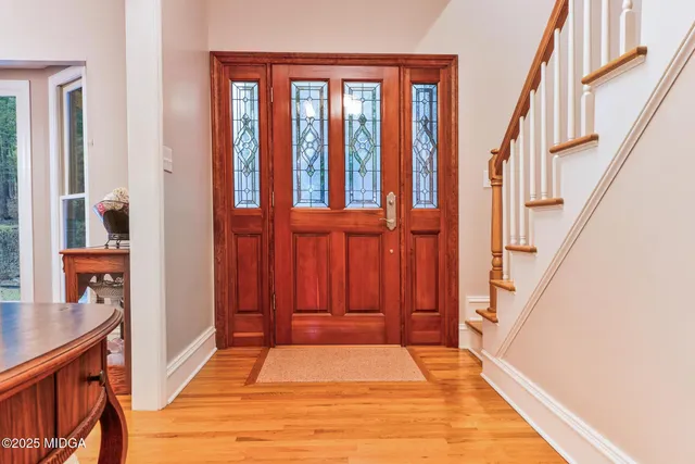 a view of entryway and hall with wooden floor