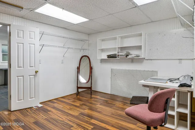 a view of a livingroom with furniture a ceiling fan and wooden floor