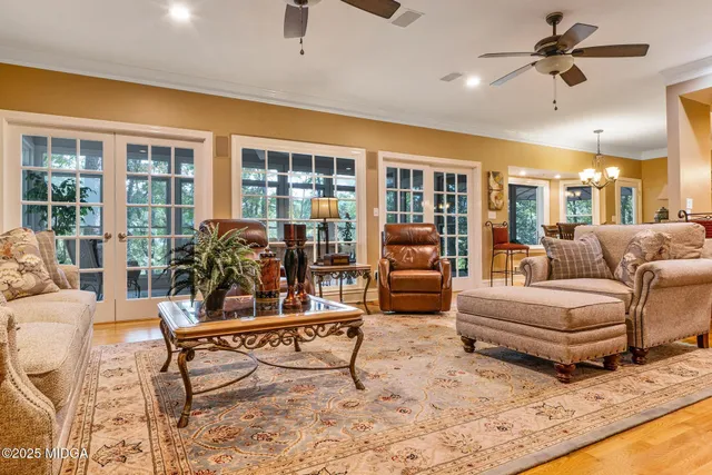 a living room with furniture and wooden floor