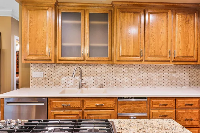 a kitchen with stainless steel appliances granite countertop a refrigerator and a stove