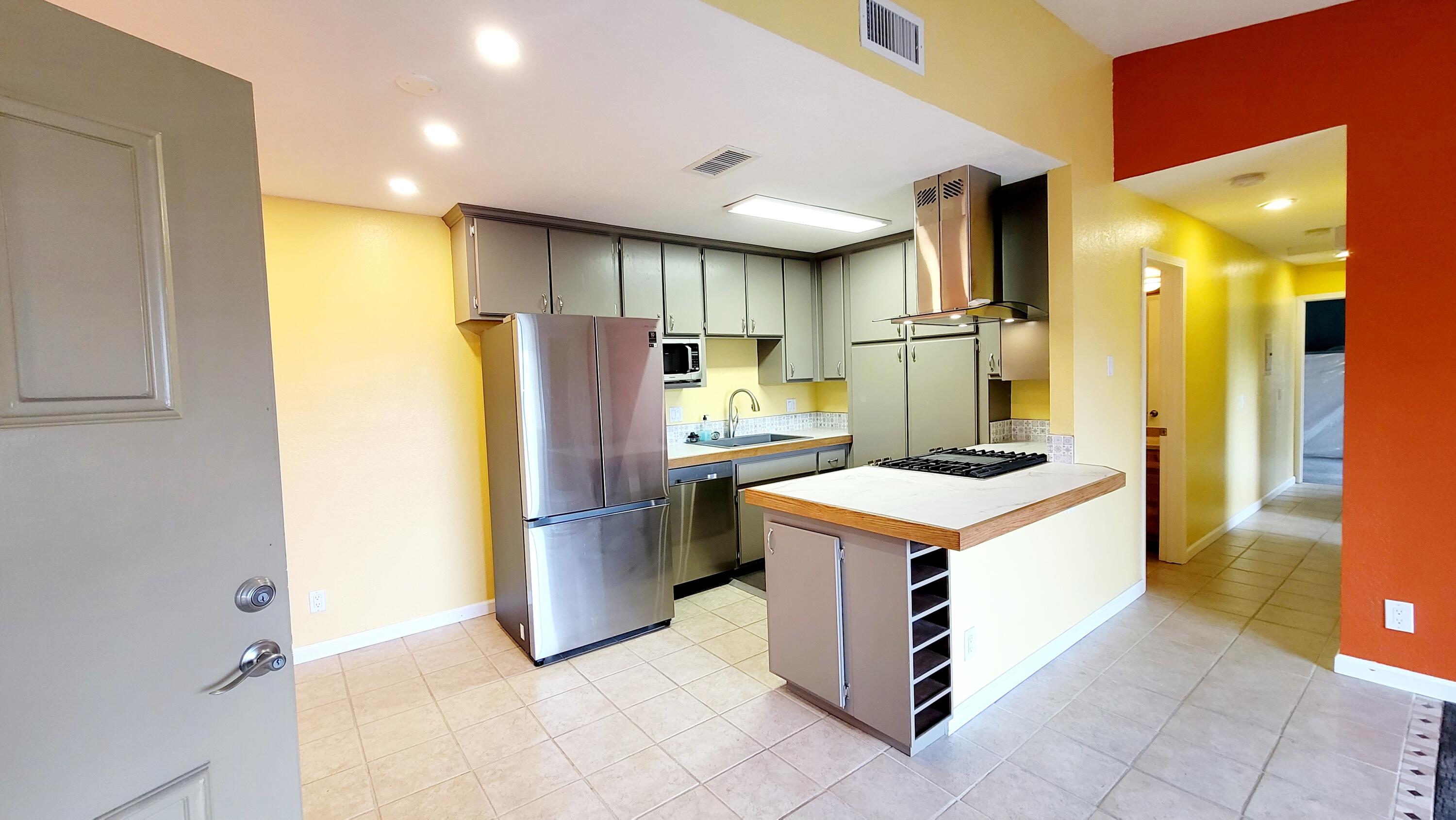 a kitchen with a refrigerator and countertop