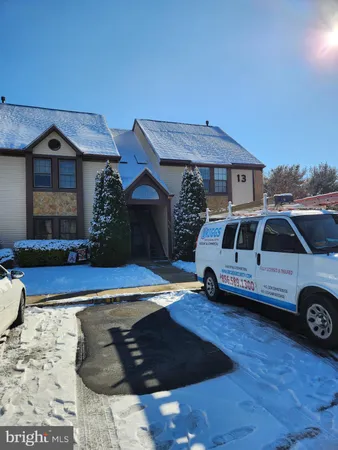 a front view of a house with parking space