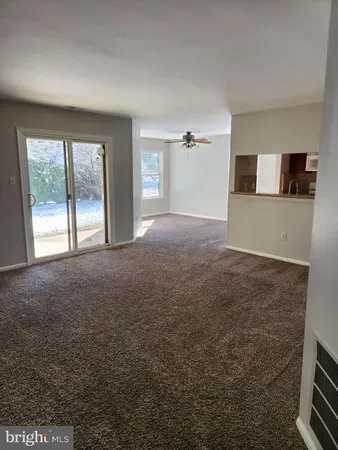 a view of a livingroom with an empty space and a window
