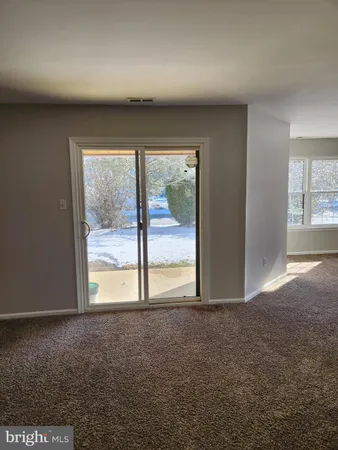 an empty room with an outdoor view and a window
