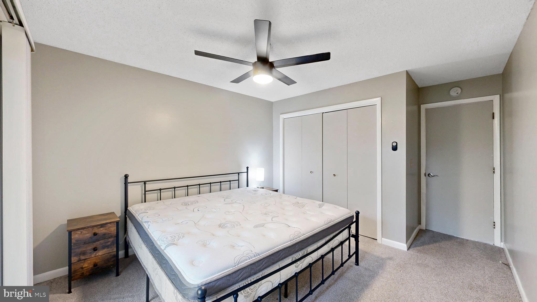 18540 Drayton Hall Road, Unit 2 Lewes, DE 19958 - Photo 23 of 38 a bedroom with a bed and a ceiling fan