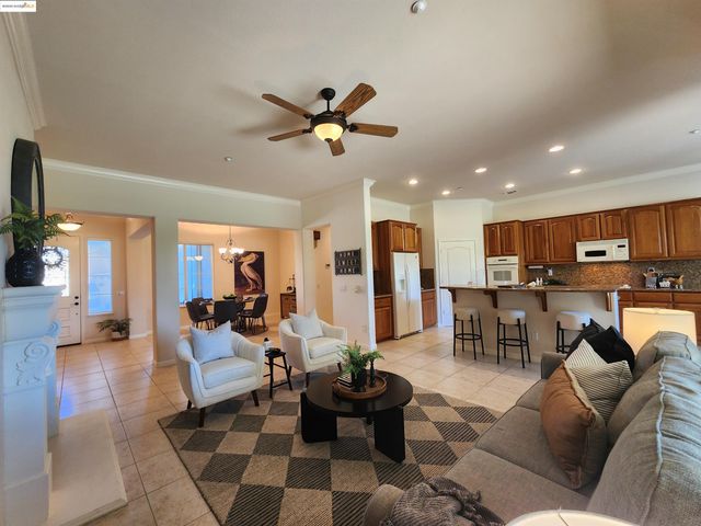 a living room with furniture a fireplace and a large window