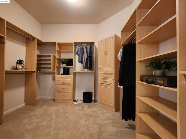 a view of a bathroom with sink shower and bedroom