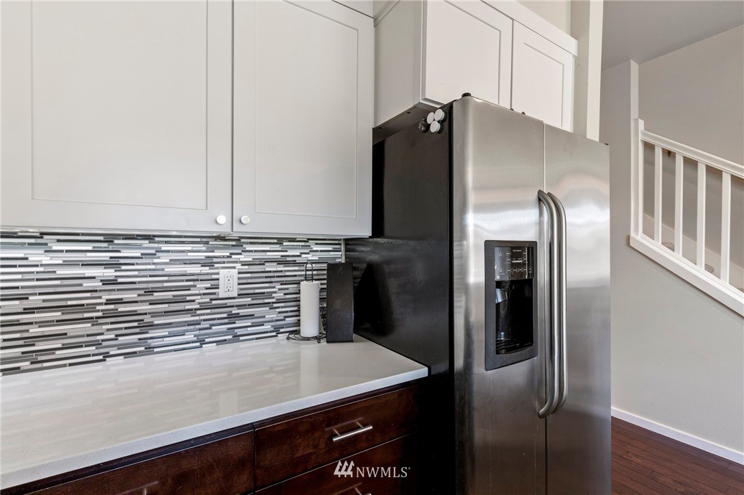 130 Cougar Ridge Road Northwest, Unit 1502 Issaquah, WA 98027 - Photo 14 of 28 a kitchen with metallic refrigerator freezer and a dishwasher