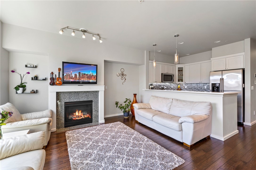 130 Cougar Ridge Road Northwest, Unit 1502 Issaquah, WA 98027 - Photo 4 of 28 a living room with furniture and a fireplace