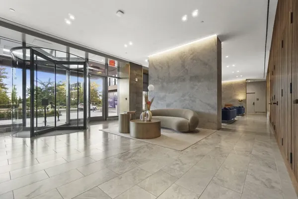 a lobby with furniture and floor to ceiling window