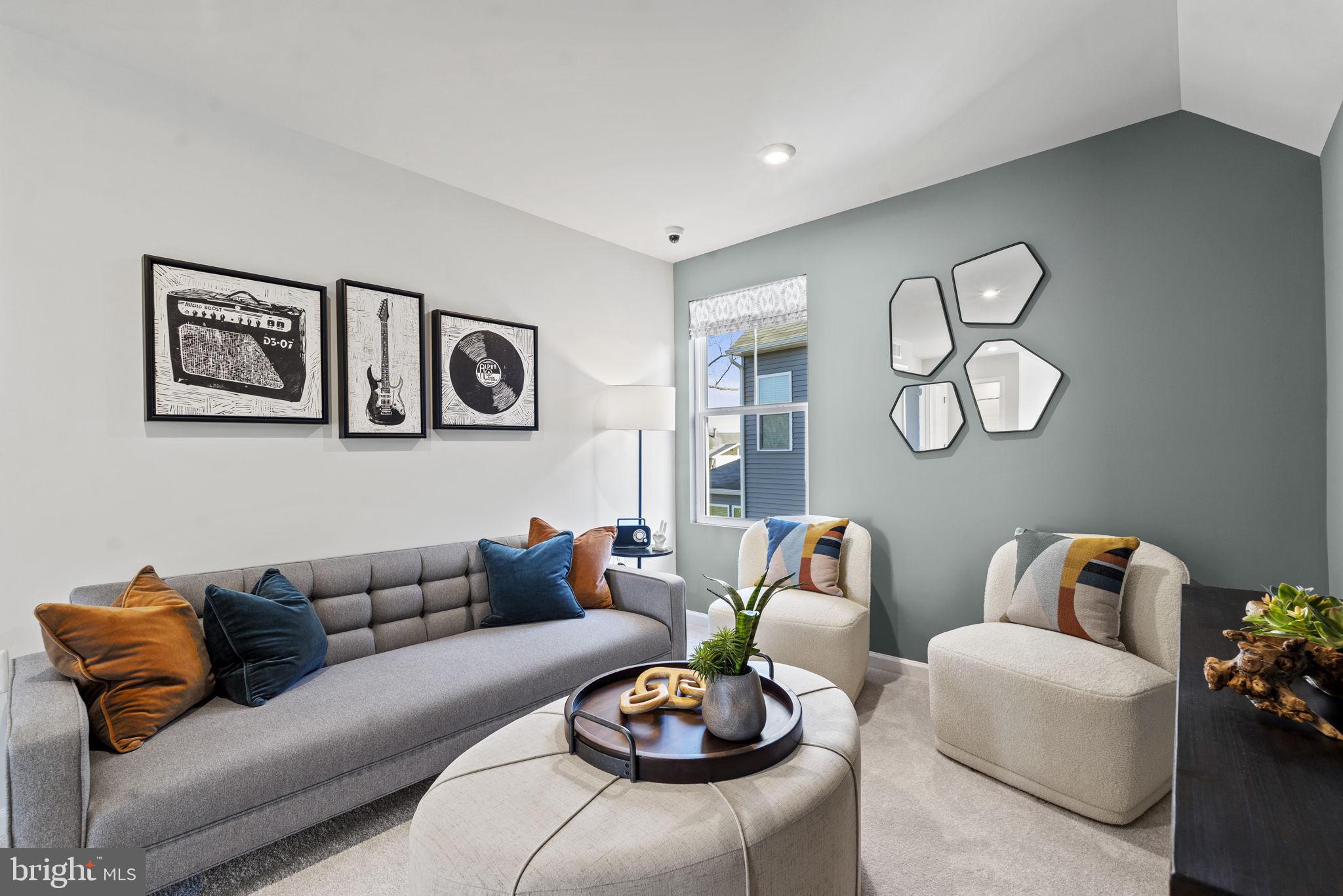 93 Taft Avenue Ranson, WV 25438 - Photo 23 of 46 a living room with furniture a rug and wall paintings