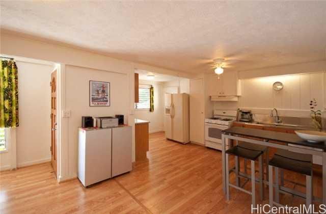 a kitchen with stainless steel appliances a refrigerator and a stove top oven
