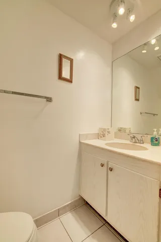 a bathroom with a sink a toilet and mirror