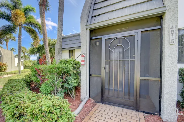 a couple of potted plants in front of door