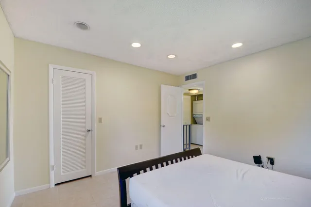 a bedroom with furniture and a large window