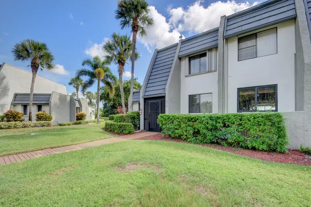 a view of a field of grass and trees