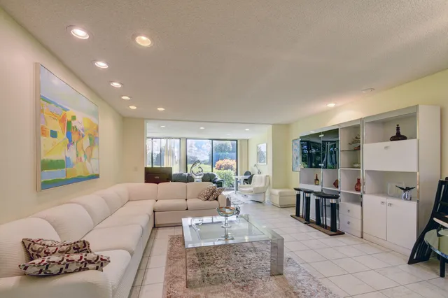 a living room with furniture and large window