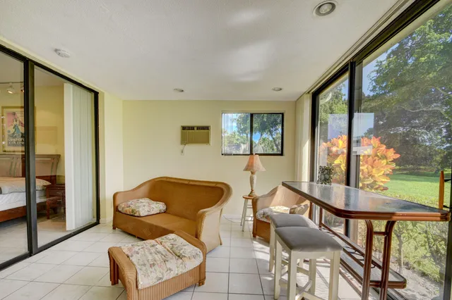 a living room with furniture and a floor to ceiling window