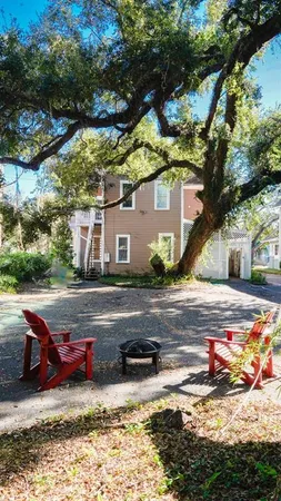 a view of a house with pool and sitting area